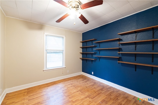 spare room with ceiling fan, light hardwood / wood-style flooring, and crown molding