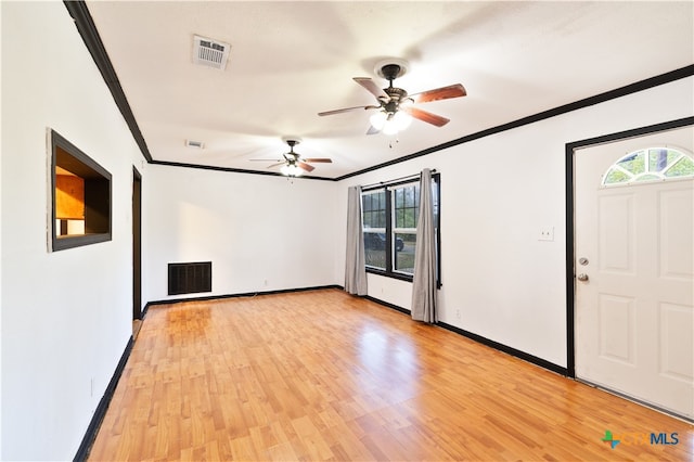 interior space with ornamental molding, light wood-type flooring, and ceiling fan