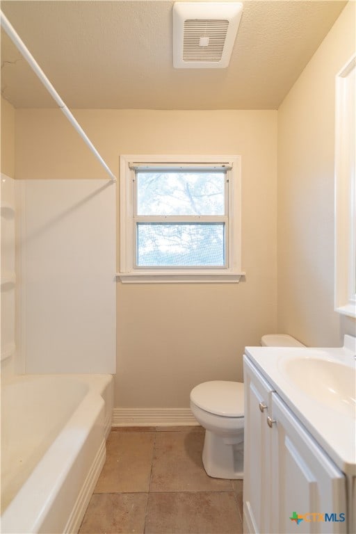 full bathroom with washtub / shower combination, vanity, tile patterned floors, and toilet