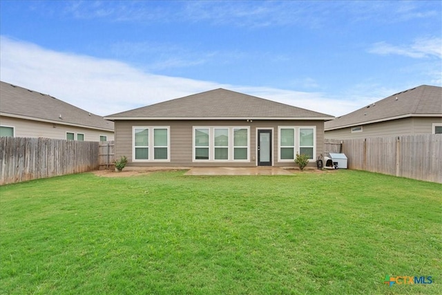 rear view of house featuring a patio and a lawn