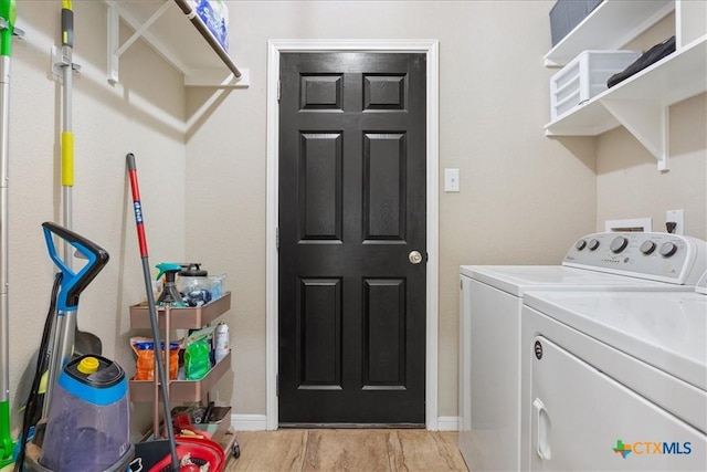 clothes washing area featuring washer and dryer