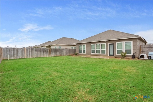 rear view of property featuring a lawn