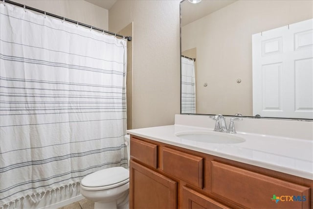 bathroom featuring vanity, tile patterned floors, and toilet