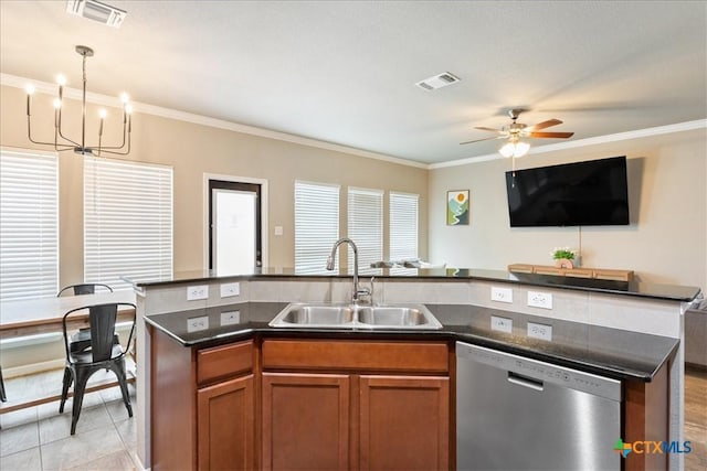 kitchen featuring sink, light tile patterned floors, a center island with sink, decorative light fixtures, and stainless steel dishwasher