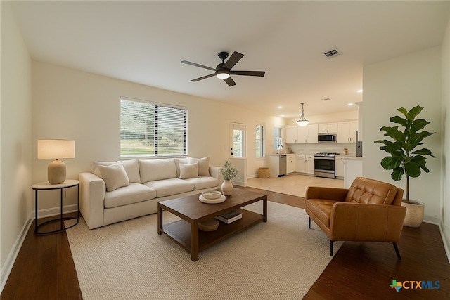1123 Sundrop Pl, Round Rock, TX 78665 - living room featuring light wood-style flooring, a ceiling fan, and baseboards