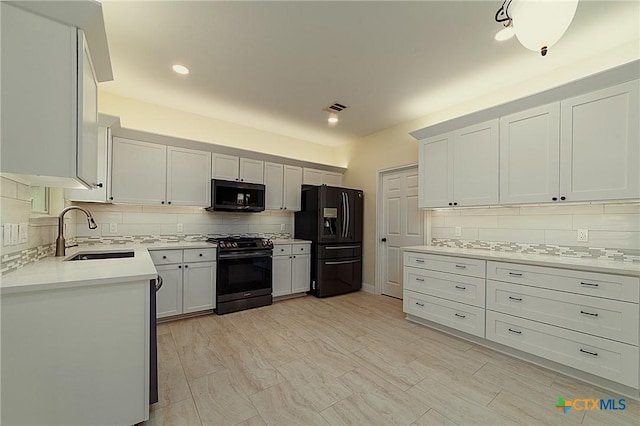 1123 Sundrop Pl, Round Rock, TX 78665 - kitchen with black appliances, a sink, backsplash, light countertops, and recessed lighting