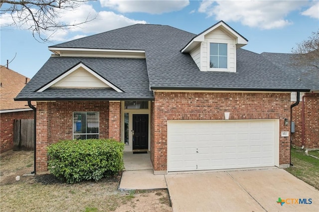 view of front facade with a shingled roof, concrete driveway, brick siding, and an attached garage