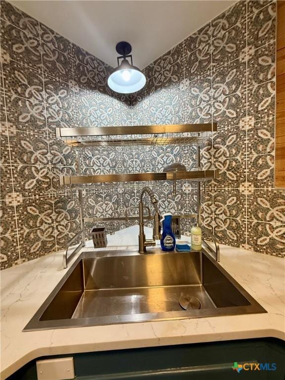 416 W Thompson Ave, Temple, TX 76501 - kitchen view of a sink, light stone counters, and decorative backsplash