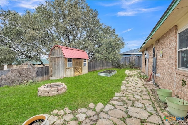 view of yard featuring an outdoor fire pit and a shed