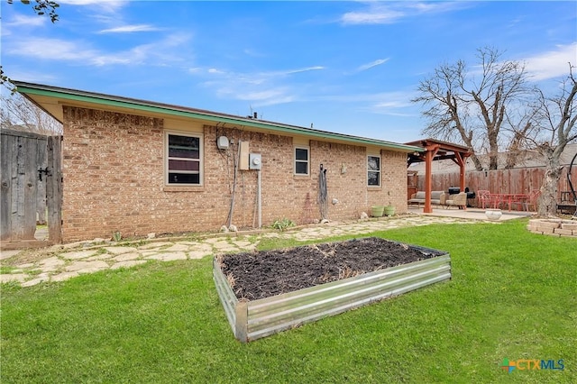 back of house featuring a patio area and a lawn