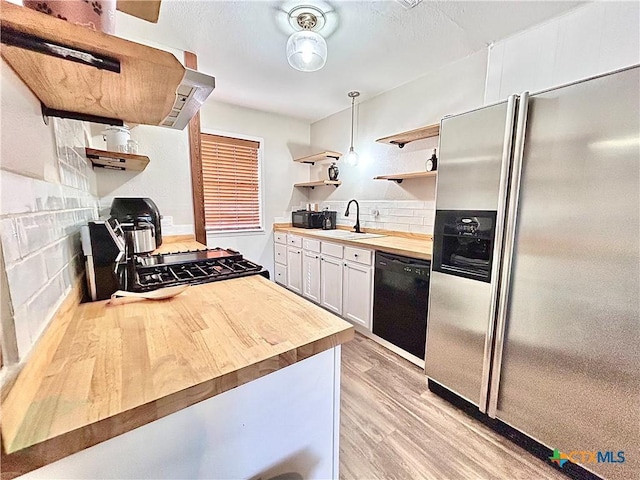 305 Carothers St, Copperas Cove, TX 76522 - kitchen featuring open shelves, black appliances, wooden counters, and light wood-style flooring
