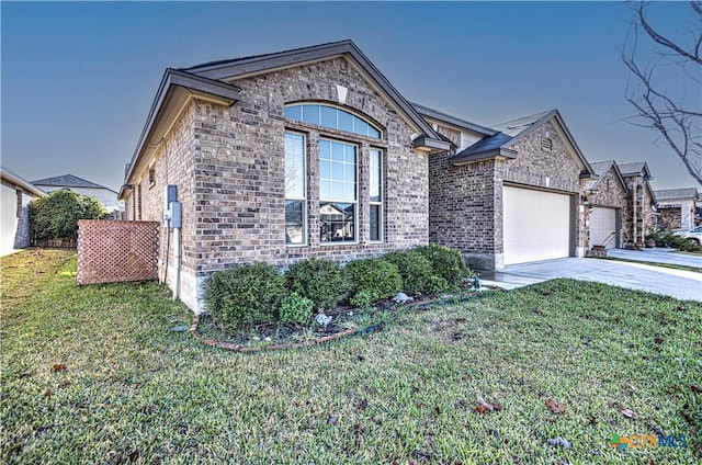 view of front of property featuring a garage and a front lawn