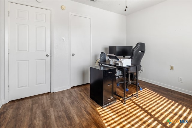 home office with dark wood-type flooring