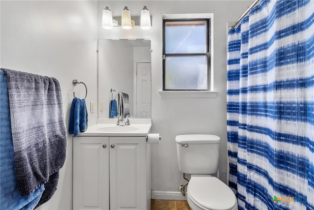 bathroom with tile patterned floors, walk in shower, vanity, and toilet