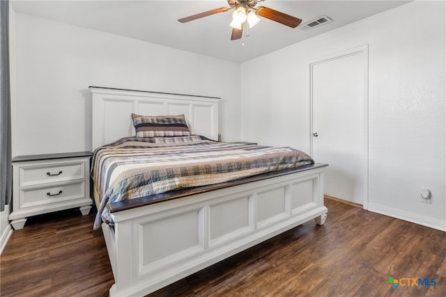 bedroom with ceiling fan and dark hardwood / wood-style flooring