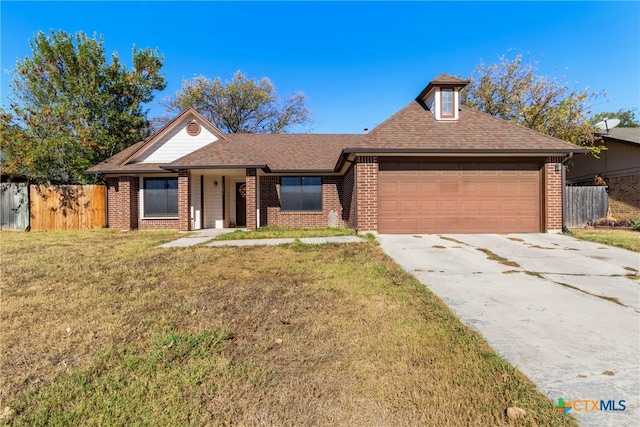 view of front of home with a garage and a front lawn