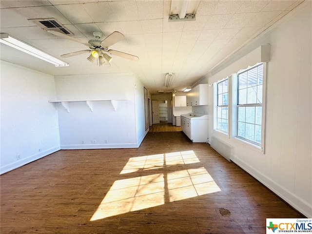 interior space featuring dark wood-type flooring and ceiling fan