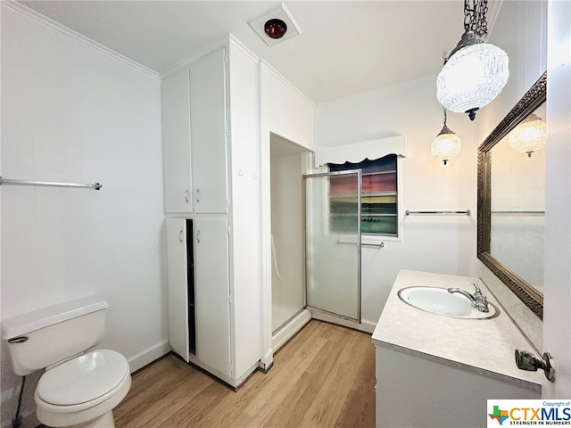 bathroom with walk in shower, vanity, wood-type flooring, and crown molding