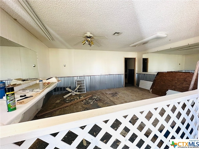 interior space featuring a textured ceiling and ceiling fan