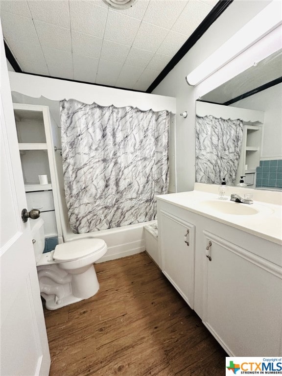 full bathroom with hardwood / wood-style floors, vanity, crown molding, shower / bath combination, and toilet