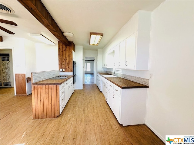 kitchen with light hardwood / wood-style floors and white cabinets