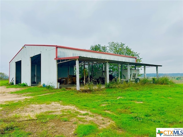 view of outbuilding with a yard