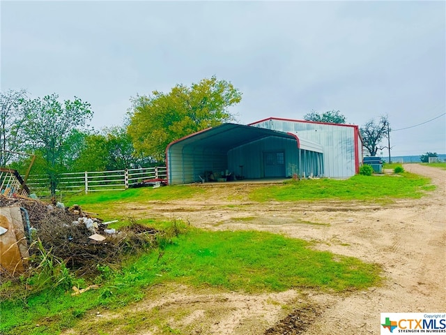 7820 Moccasin Bend Rd, Gatesville, TX 76528 - view of outdoor structure featuring a detached carport and dirt driveway