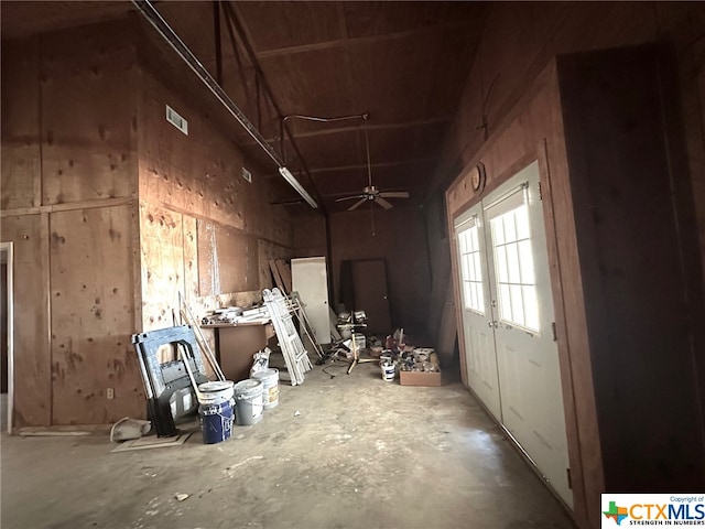 misc room with concrete flooring and ceiling fan