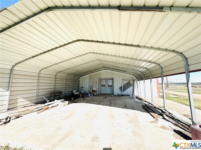 view of parking / parking lot featuring a carport