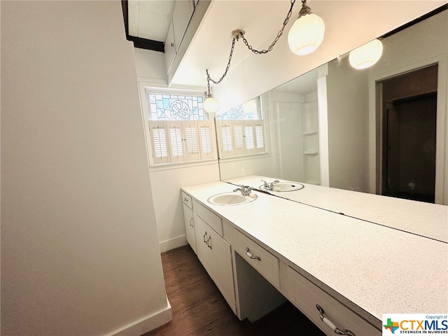 bathroom with vanity and hardwood / wood-style flooring