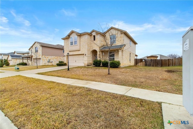 view of property featuring a front yard and a garage