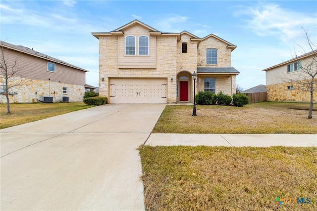 view of front property featuring cooling unit, a garage, and a front lawn