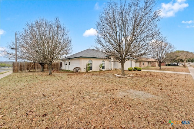 view of side of property featuring fence