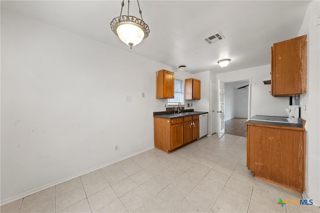 kitchen with a sink, visible vents, dark countertops, and dishwasher