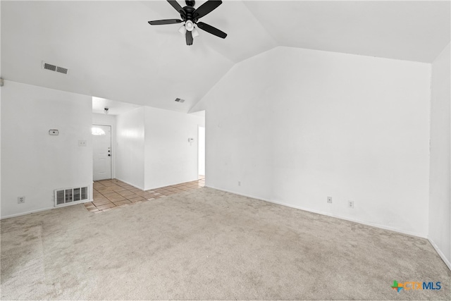 unfurnished living room featuring light colored carpet, vaulted ceiling, and ceiling fan