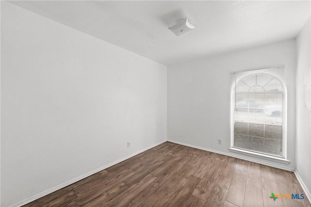 unfurnished room featuring hardwood / wood-style flooring