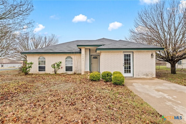 single story home featuring brick siding