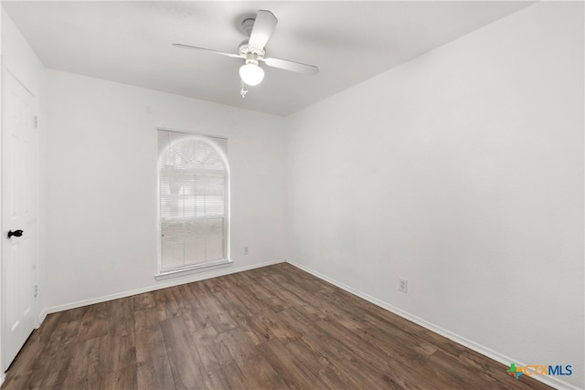 empty room featuring baseboards, wood finished floors, and a ceiling fan