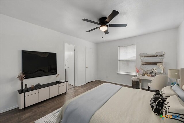 empty room featuring ceiling fan and dark wood-type flooring