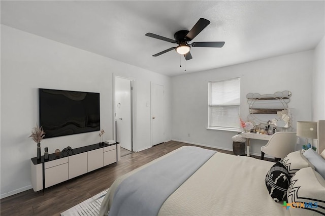 bedroom with baseboards, wood finished floors, and a ceiling fan