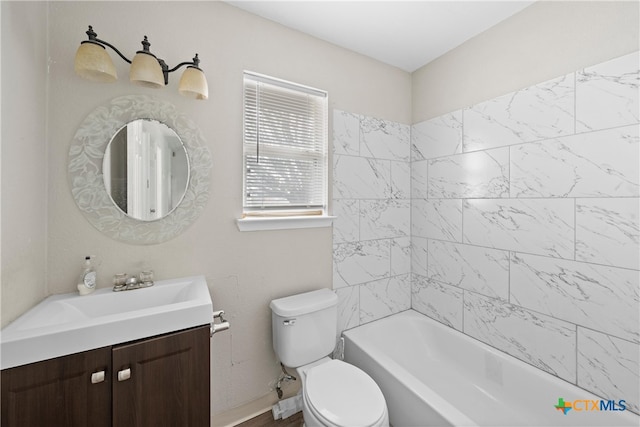 full bathroom with vanity, toilet, and tiled shower / bath combo