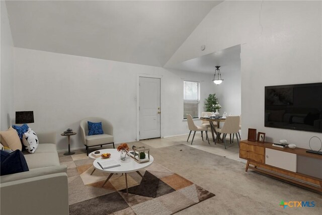 interior space featuring vaulted ceiling, ceiling fan, and light tile patterned flooring