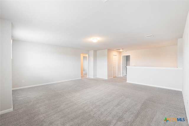 unfurnished room featuring carpet and baseboards