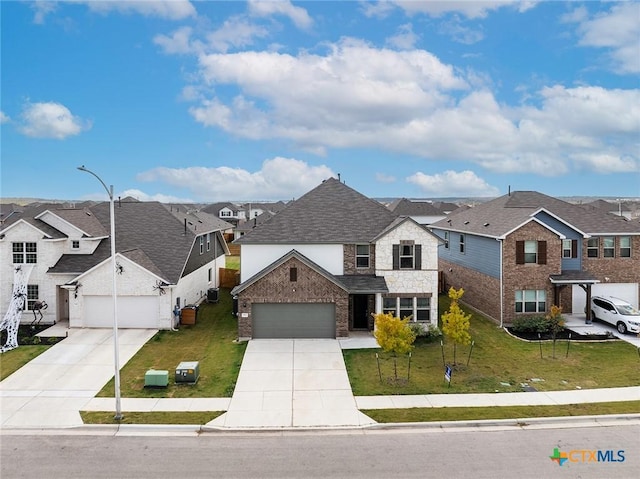 traditional-style home with a residential view, a garage, concrete driveway, and a front lawn