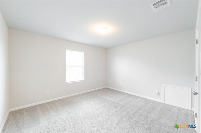 unfurnished room with carpet flooring, baseboards, and visible vents