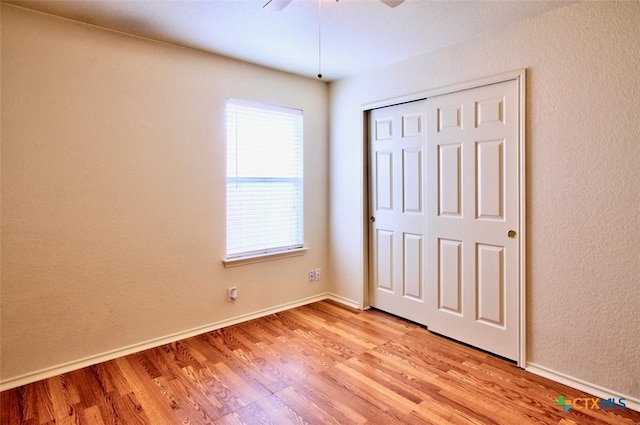 219 Starling Crk, New Braunfels, TX 78130 - unfurnished bedroom with light wood-style floors, baseboards, a closet, and a ceiling fan