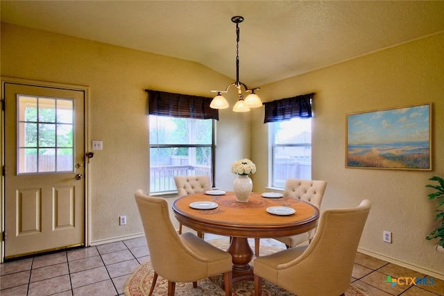 219 Starling Crk, New Braunfels, TX 78130 - dining room with a chandelier, light tile patterned floors, lofted ceiling, a textured wall, and baseboards