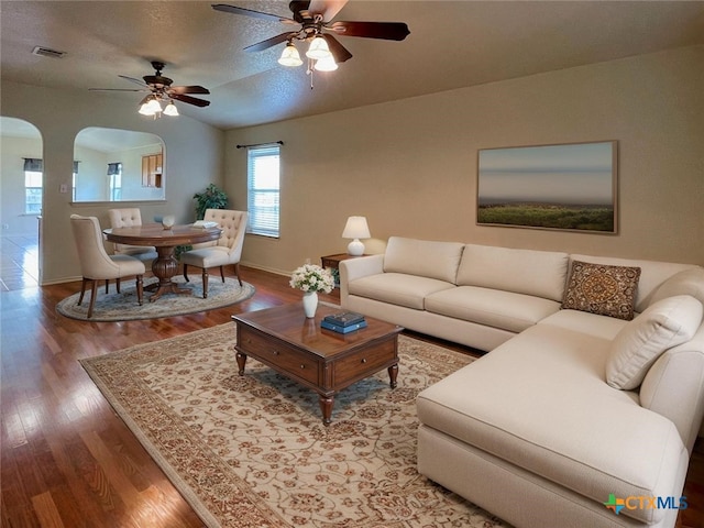 219 Starling Crk, New Braunfels, TX 78130 - living room featuring arched walkways, wood finished floors, vaulted ceiling, baseboards, and ceiling fan