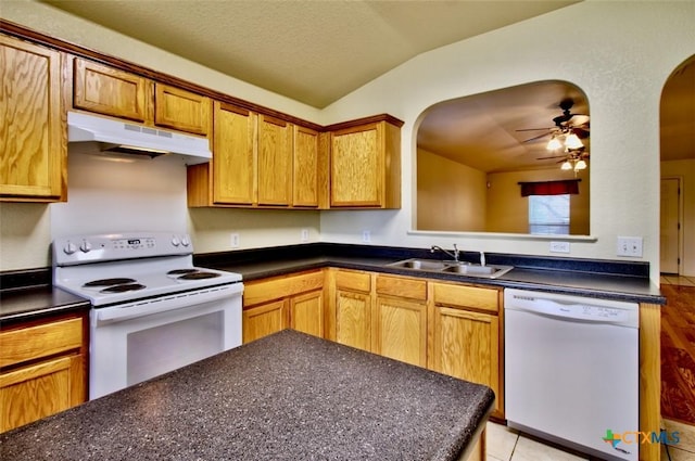 219 Starling Crk, New Braunfels, TX 78130 - kitchen with white appliances, under cabinet range hood, a sink, arched walkways, and dark countertops