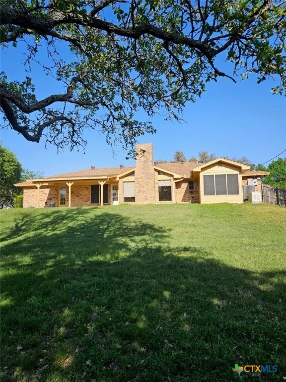 back of property with a lawn